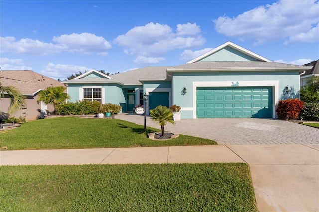 ranch-style home with a garage and a front yard