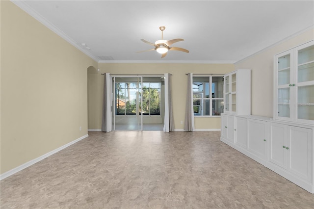 unfurnished room featuring ceiling fan and ornamental molding