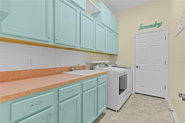 washroom featuring cabinets, washer and dryer, and sink