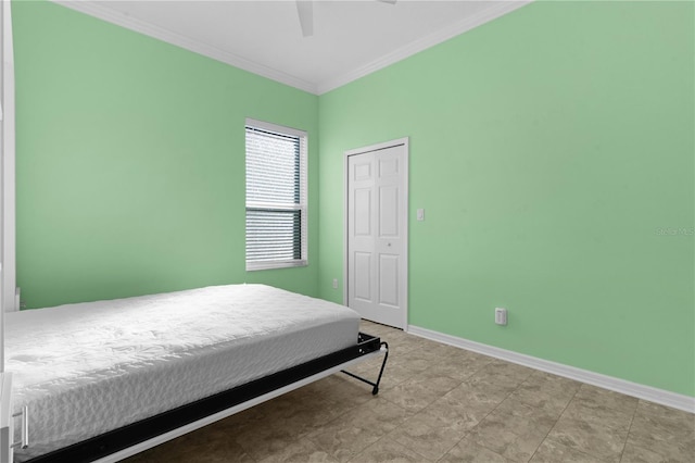 bedroom with ceiling fan, a closet, and crown molding