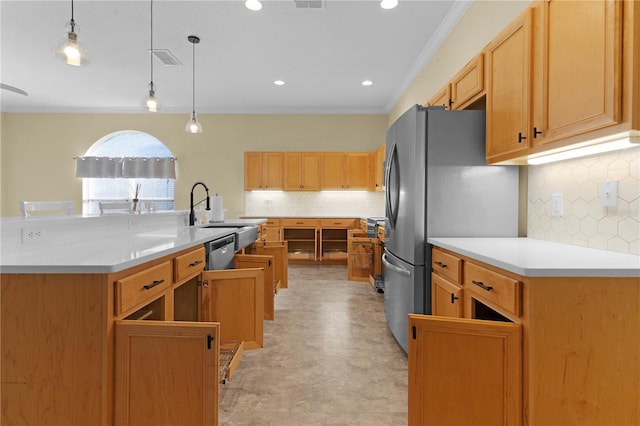 kitchen featuring pendant lighting, appliances with stainless steel finishes, decorative backsplash, sink, and crown molding