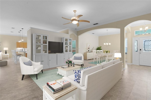 25304 Forest Oak Ct, Leesburg, FL 34748 - living area featuring ceiling fan with notable chandelier, visible vents, arched walkways, and crown molding