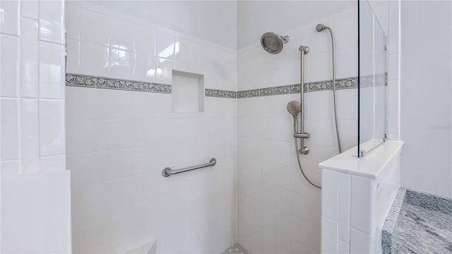 bathroom with a tile shower