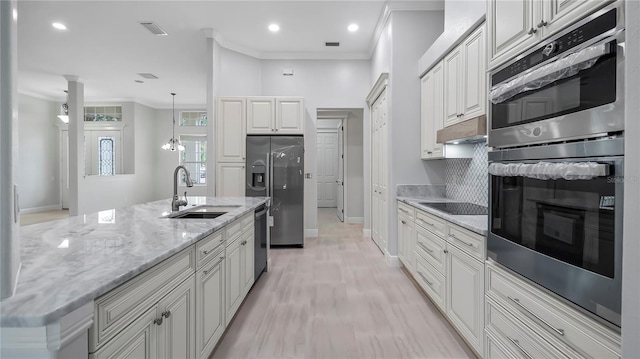 kitchen featuring ornamental molding, stainless steel appliances, sink, and tasteful backsplash