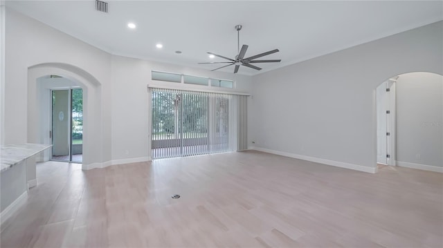 empty room with light wood-type flooring, a wealth of natural light, and ceiling fan