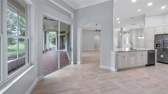 kitchen with ceiling fan, appliances with stainless steel finishes, plenty of natural light, and sink