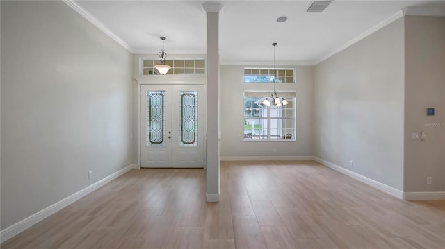 entryway featuring french doors, a notable chandelier, light hardwood / wood-style flooring, and crown molding