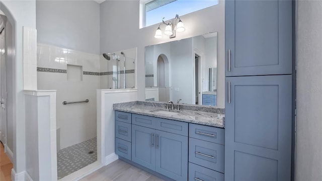 bathroom featuring vanity and tiled shower