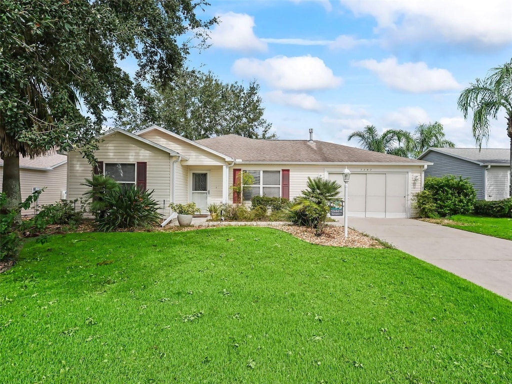 ranch-style house with a garage and a front lawn