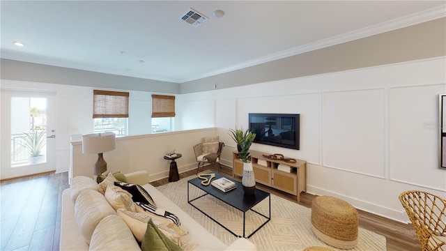 living room with ornamental molding and hardwood / wood-style floors