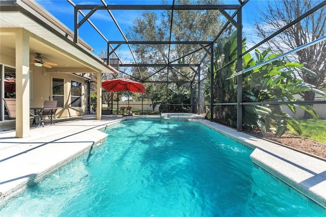 view of pool featuring ceiling fan, a patio area, and a lanai