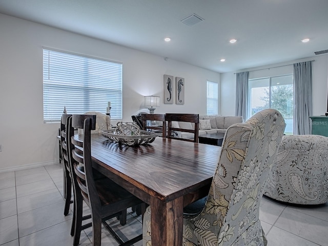 tiled dining area featuring a healthy amount of sunlight