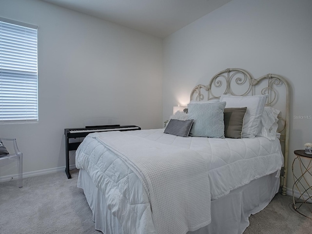 carpeted bedroom with vaulted ceiling