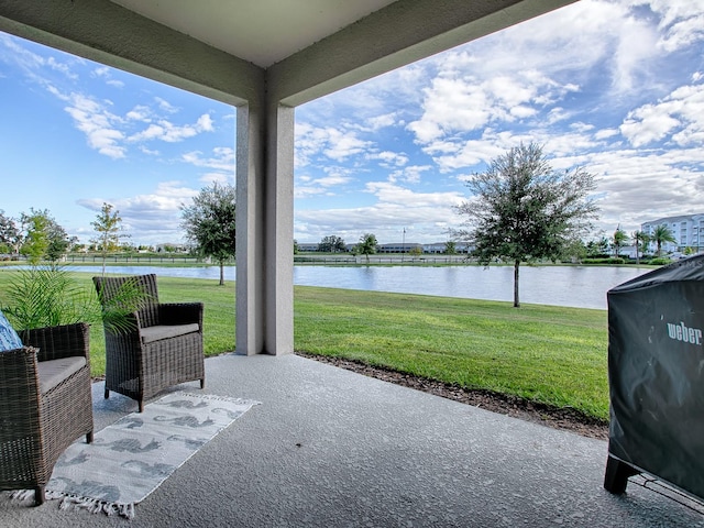 view of patio featuring a water view and grilling area