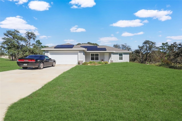 ranch-style house featuring a front yard, solar panels, and a garage