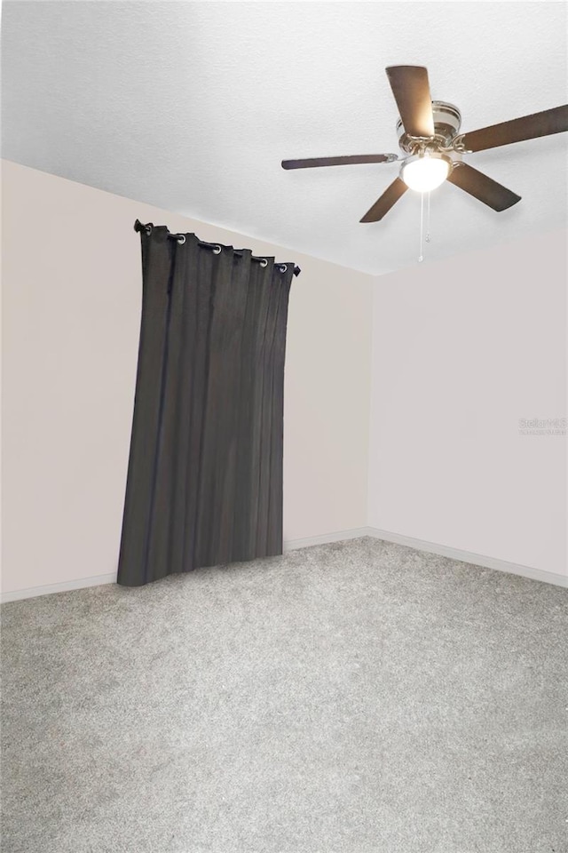 unfurnished room featuring a textured ceiling, carpet flooring, and ceiling fan