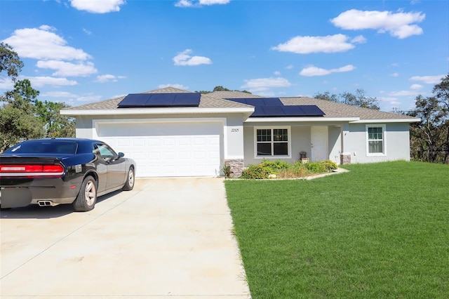 ranch-style home featuring solar panels, a front yard, and a garage