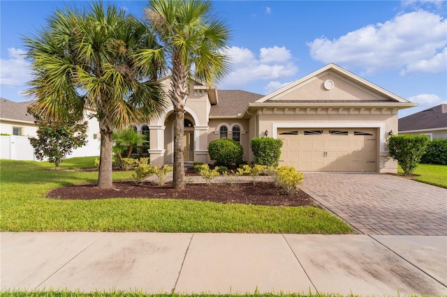 view of front facade with a front yard and a garage