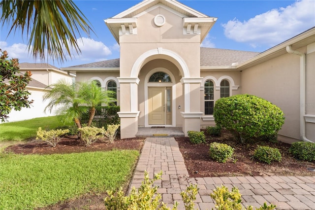 doorway to property with a yard