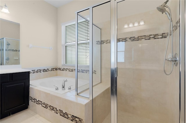 bathroom with tile patterned flooring, vanity, and independent shower and bath