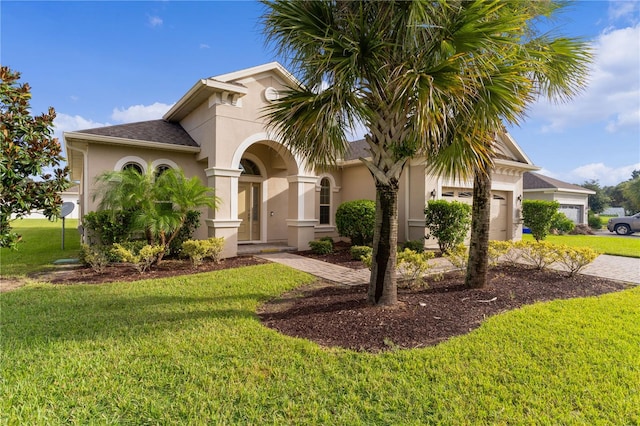 mediterranean / spanish-style home featuring a garage and a front lawn