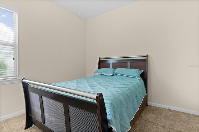 bedroom featuring light colored carpet