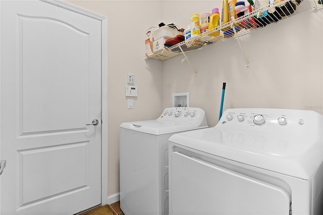 clothes washing area with washing machine and dryer