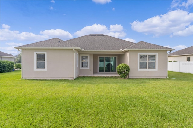 rear view of property featuring a yard