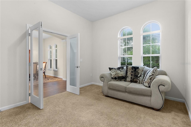 sitting room with light carpet and french doors