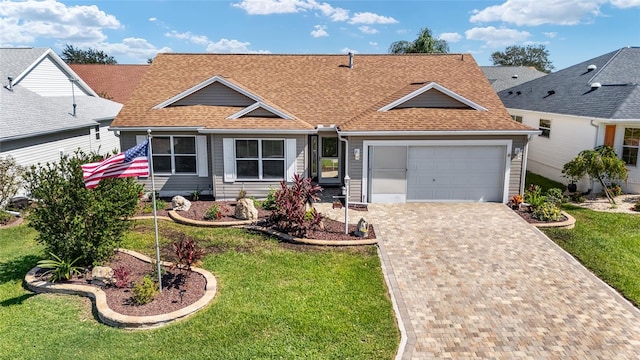 single story home featuring a garage and a front lawn