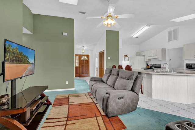 tiled living room with sink, high vaulted ceiling, and ceiling fan