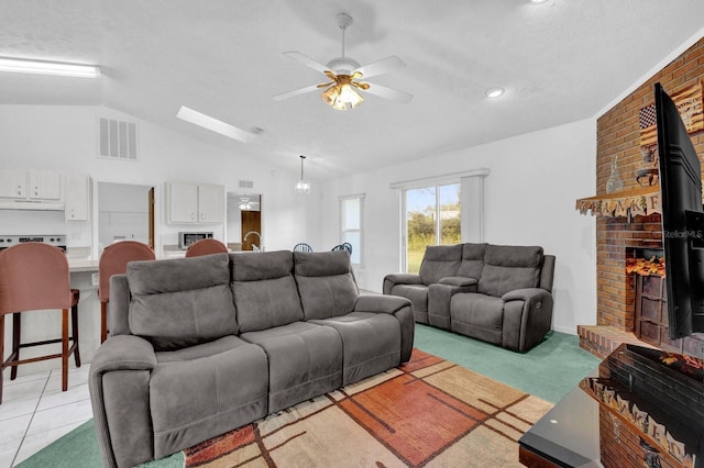 carpeted living room with lofted ceiling, a textured ceiling, a fireplace, and ceiling fan