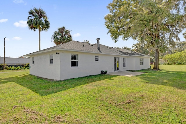 back of property featuring a yard and a patio area