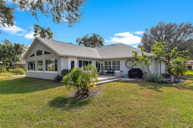 rear view of house with a yard