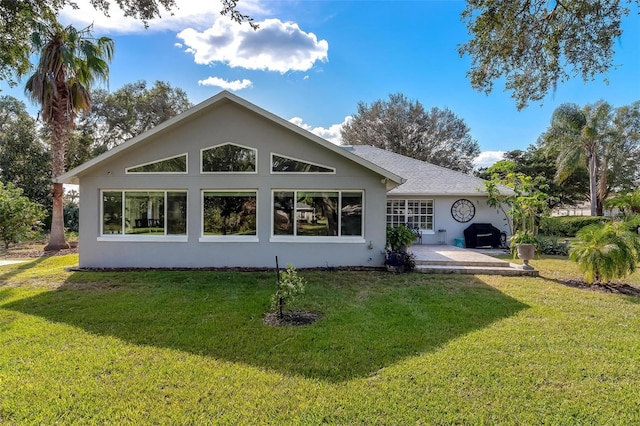 rear view of house featuring a yard and a patio area