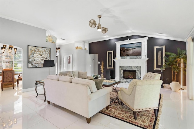 tiled living room with a high end fireplace and crown molding