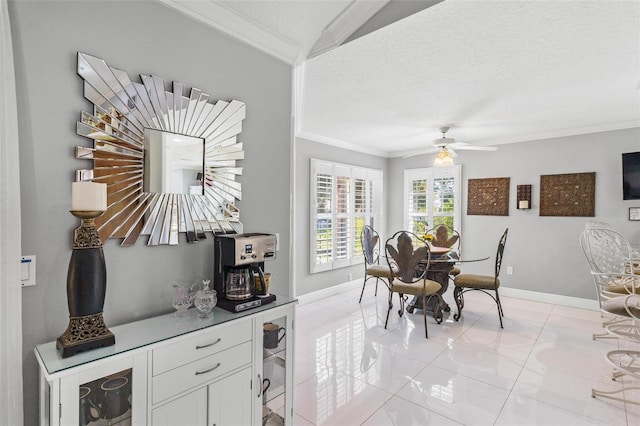 dining room featuring crown molding, light tile patterned flooring, a textured ceiling, and ceiling fan