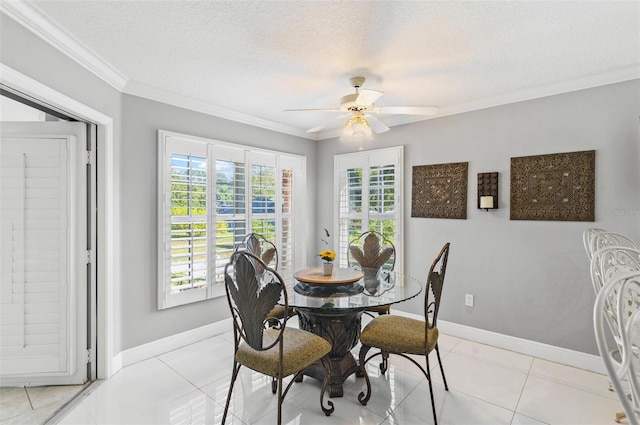 dining room with ceiling fan, crown molding, a textured ceiling, and light tile patterned floors