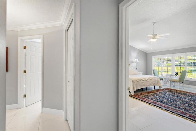 tiled bedroom with ornamental molding, a textured ceiling, and ceiling fan