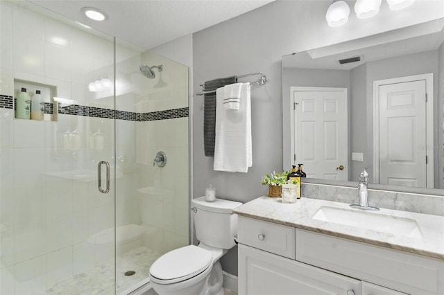 bathroom with vanity, toilet, and walk in shower