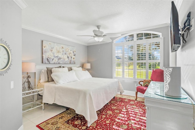 tiled bedroom featuring ornamental molding, a textured ceiling, and ceiling fan