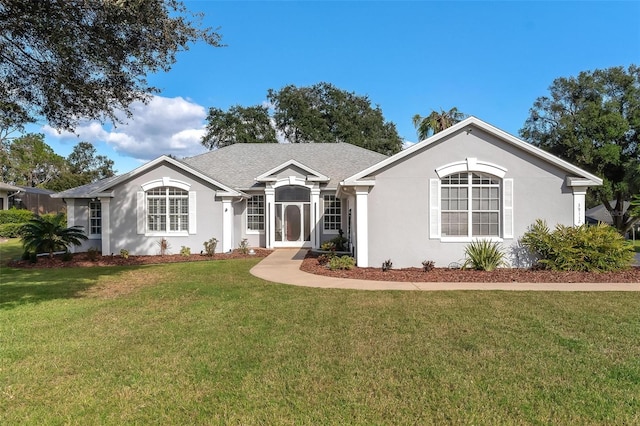 ranch-style home featuring a front lawn