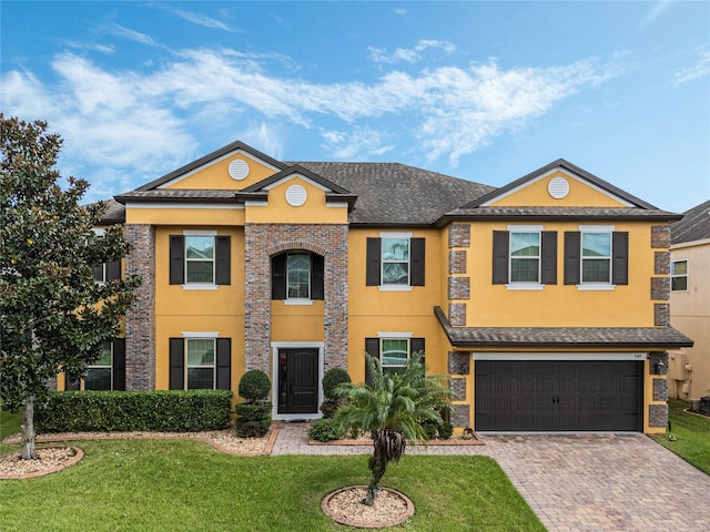 349 Morning View Dr, Winter Garden, FL 34787 - view of front of property featuring stucco siding, decorative driveway, a front lawn, and an attached garage