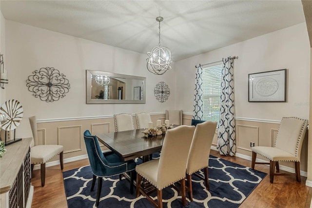 dining space featuring hardwood / wood-style floors and a chandelier