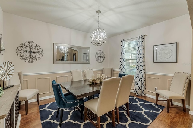349 Morning View Dr, Winter Garden, FL 34787 - dining space featuring a chandelier, wood finished floors, a decorative wall, and a wainscoted wall