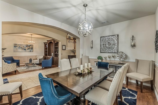 349 Morning View Dr, Winter Garden, FL 34787 - dining space featuring a chandelier, wood finished floors, and arched walkways