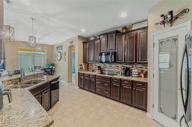 kitchen featuring dark brown cabinetry, pendant lighting, sink, tasteful backsplash, and black appliances