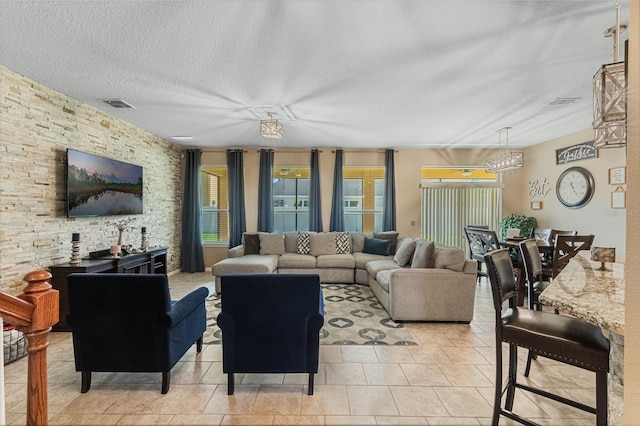 living room with light tile patterned floors and a textured ceiling