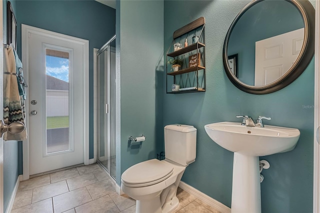 bathroom with an enclosed shower, tile patterned floors, and toilet