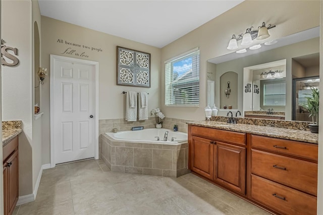 bathroom with tile patterned flooring, plus walk in shower, and vanity